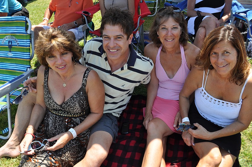 Leslie Medenwald, Frank Lee, Patti Kelly and Laura Corella find a shady spot under an umbrella.