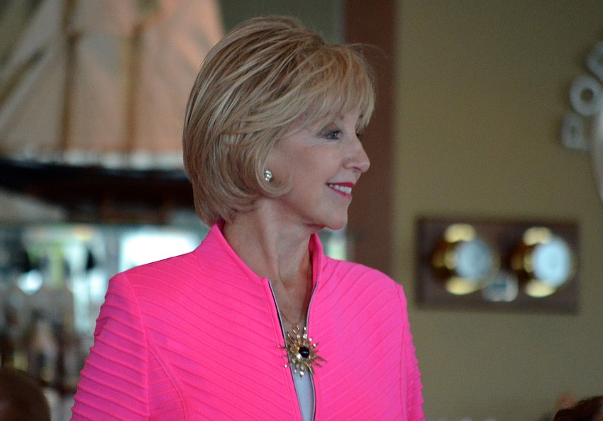 Susan Gilmore Clarke smiles as she models a bright fuchsia jacket.