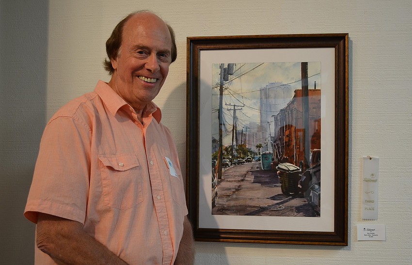 Ken Snyder stands by â€œBack Alley â€“ Sarasota,â€ his painting that won third place.