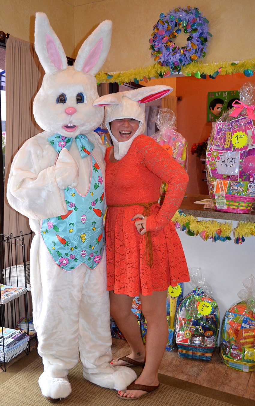 The Easter Bunny poses with Sand Cay employee Olivia Cherry.