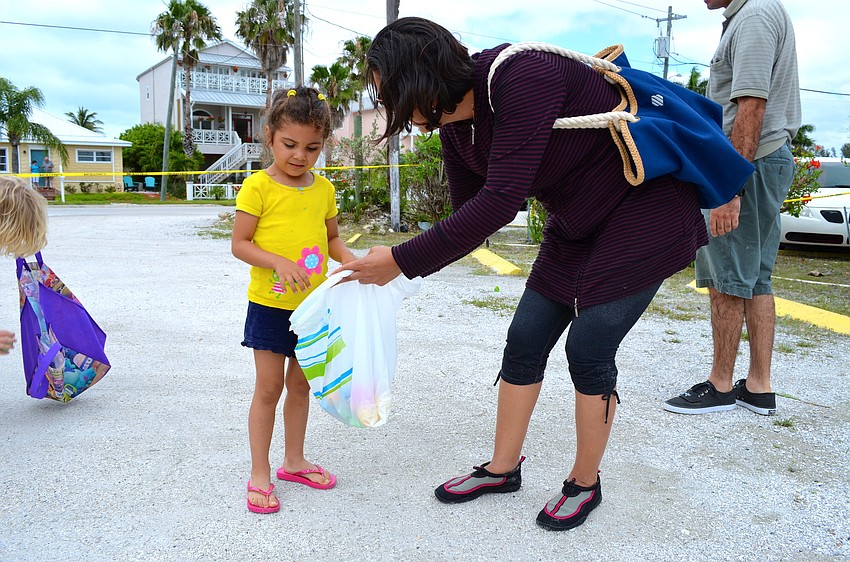 Ana Cristina Socas and her mother, Veronica Socas, collect eggs.