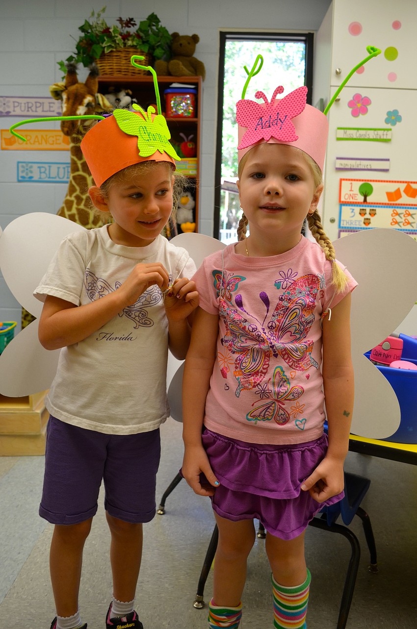 Five-year-olds Chiana Webber and Addy Hartley get ready to go outside.