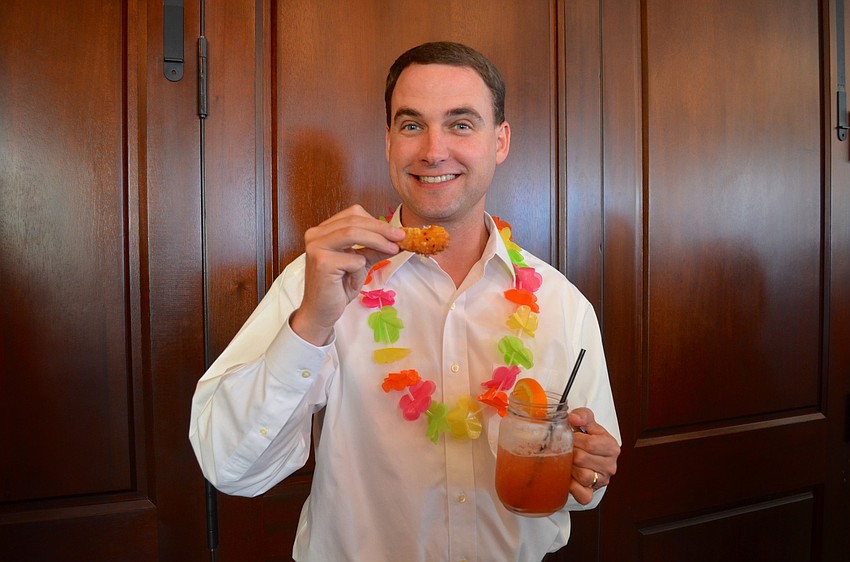 Chris Fensterle enjoys a cocktail and a snack.