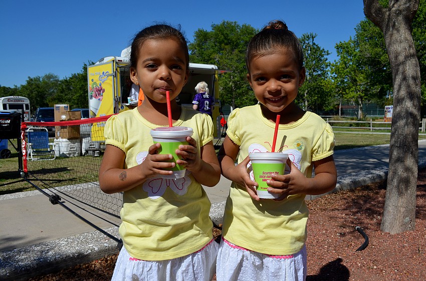 Joleisy Walker and her sister, Destiny, cool down with smoothies.