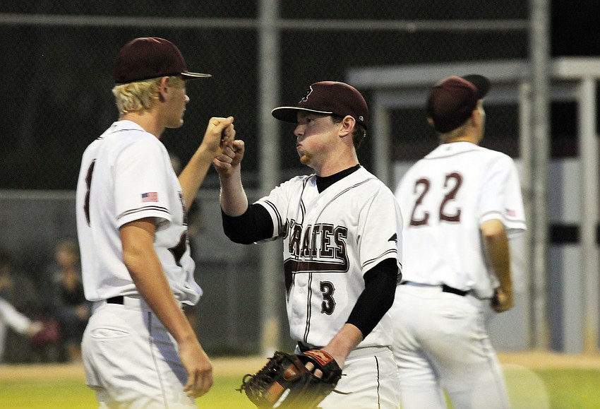 Braden Riverâ€™s Tyler Pogue congratulates pitcher Brooks Norton on another scoreless inning.
