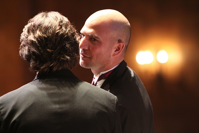 Joseph Sckowska whispers to his best man, Jeremy Parrett.