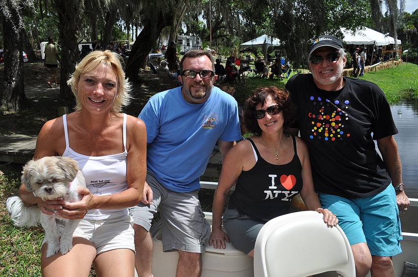 Brenda and Dave Gradl and Pam and Bruce Finn in the Gradlâ€™s boat, which they bring to the festival every year.