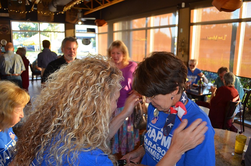 Jennifer Ahearn-Koch congratulates Susan Chapman.