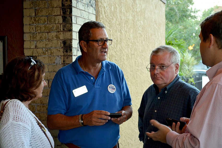 Richard Dorfman talks with supporters at his watch party.