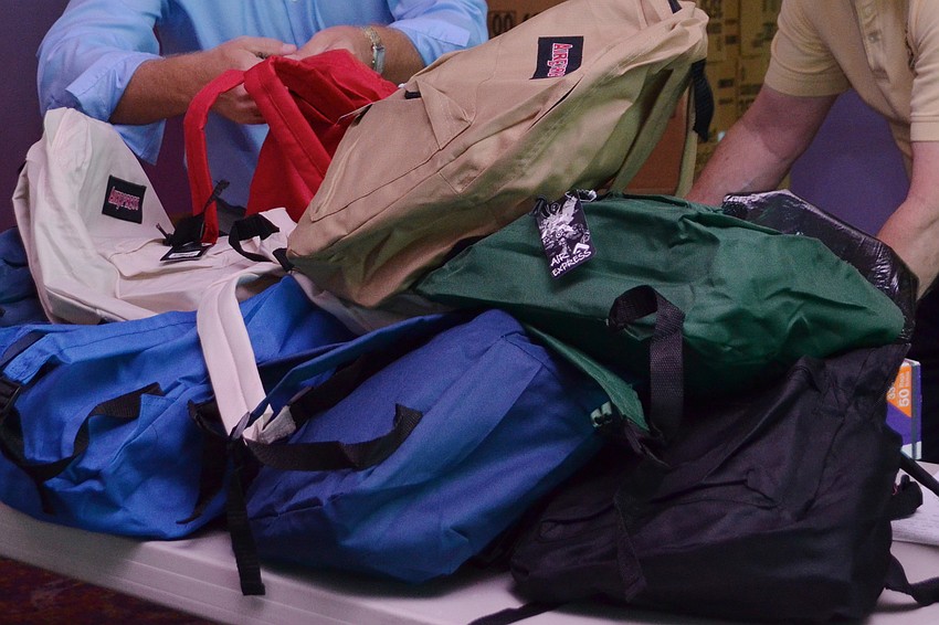 Backpacks filled with school supplies are distributed to elementary schools in the area.