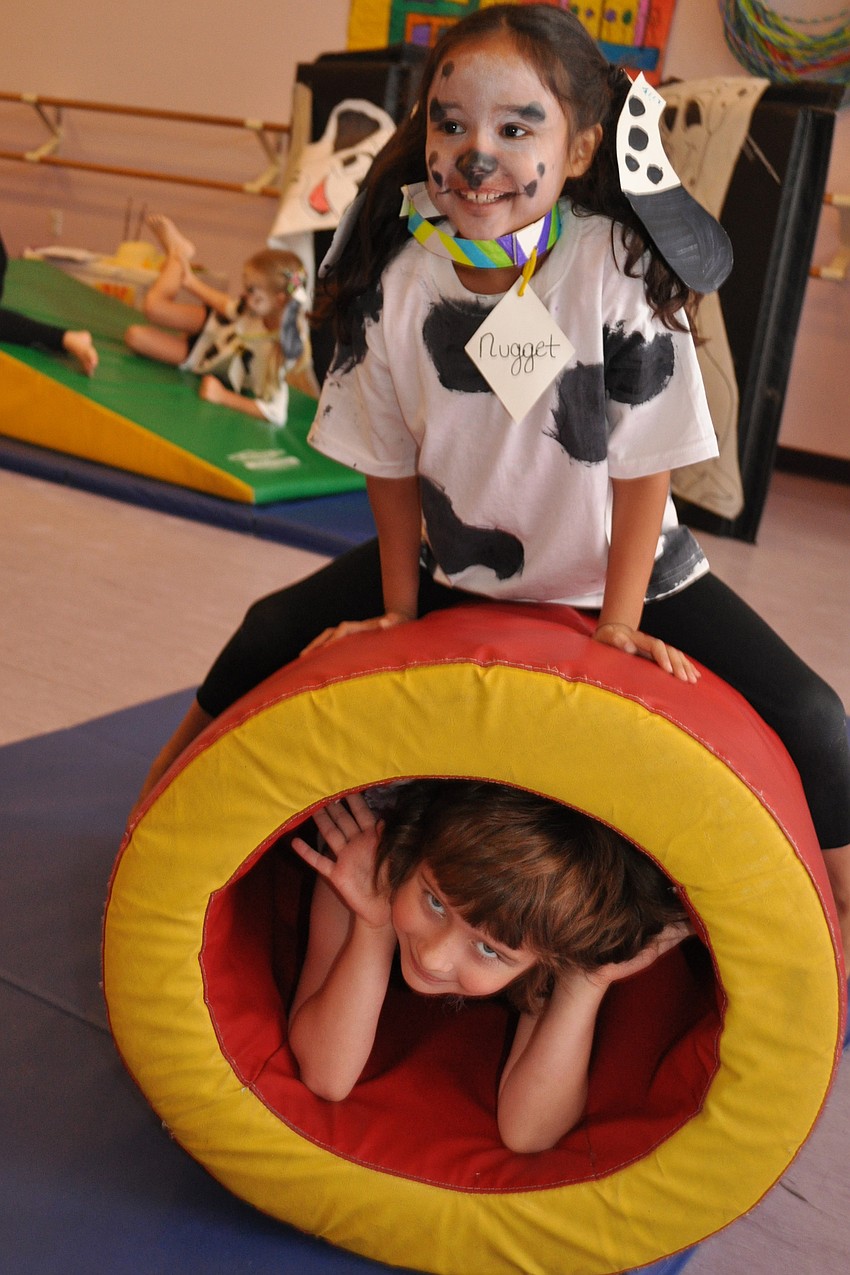 Micaela Castro, top, and Anna Chioffe, below, celebrate the puppiesâ€™ return home.