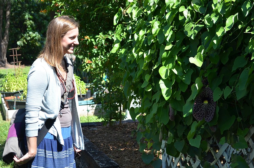 Colleen McGue walks through the newly revived butterfly garden at Plymouth Harbor.
