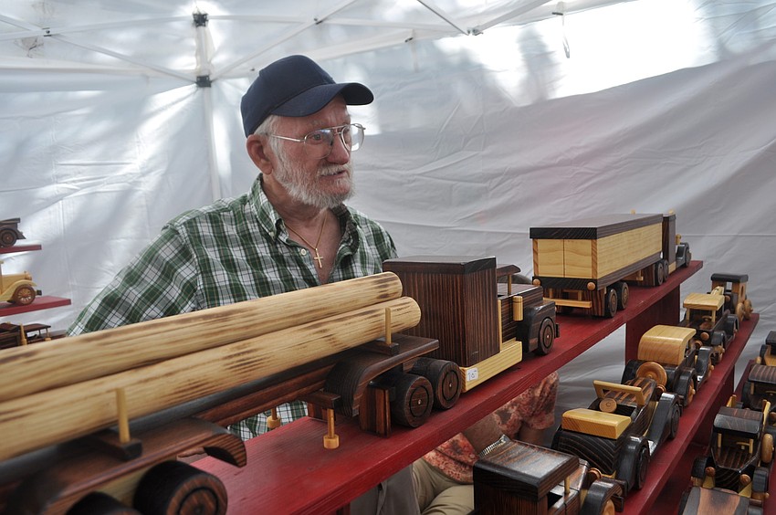 A vendor sold antique vehicles made of wood.