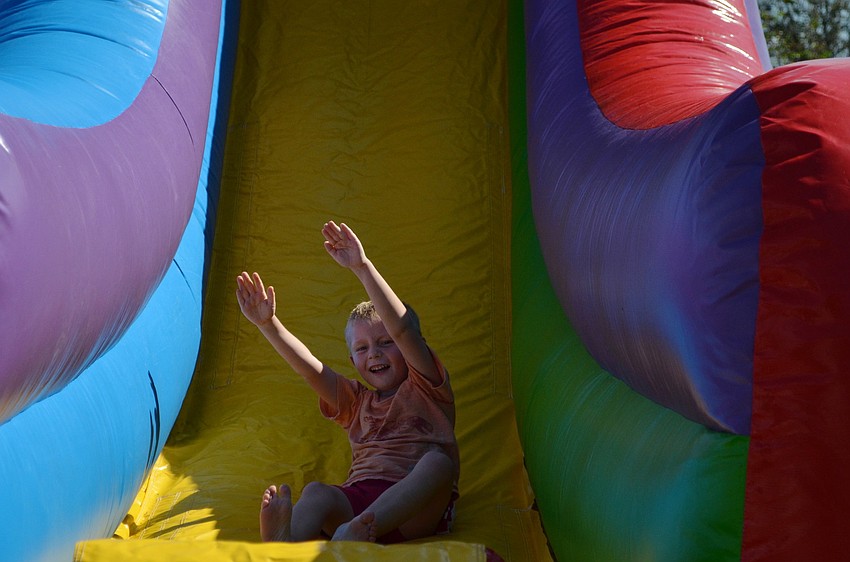 Samual Klein goes down the bouncy slide.