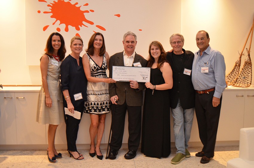 Michelle Young, Cynthia Peterson, Heather Chapell, Wilson Stiles, Lily Chapell, Jim Keaton and Alan Sprintz with the $85,000 Heather Chapell donated to CFAS.