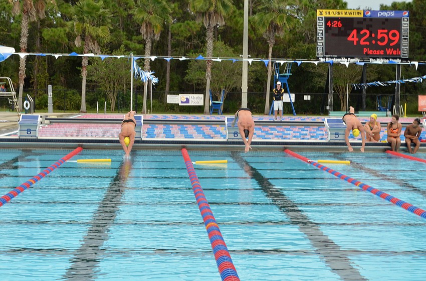 Senior Sharks Liam McKane and Alex Katz race Ryan Lochte in a 25-meter sprint Thursday, Oct. 24, at The Selby Aquatic Center.