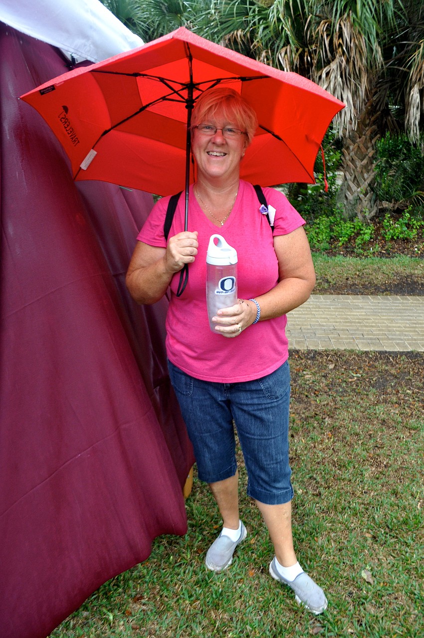 Barb Poole hides from the rain.
