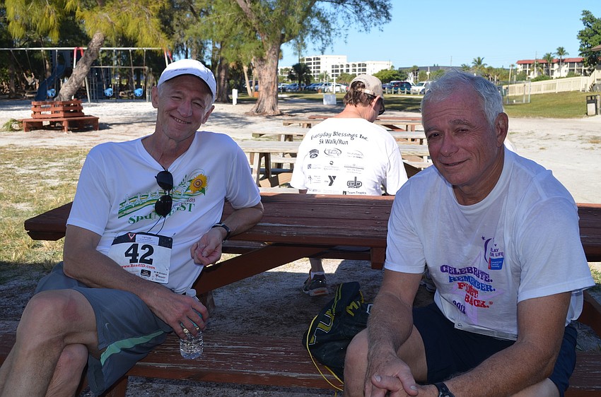 Mike Murphy and Dan Najjar sit in the shade
