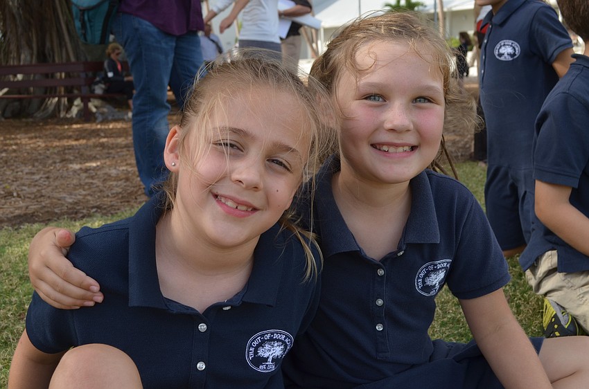 Kendall C. and Rachel C. sit on the sidelines