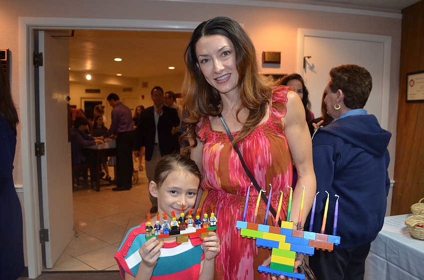 Kim and daughter Lily Schlosberg with their handmade menorahs