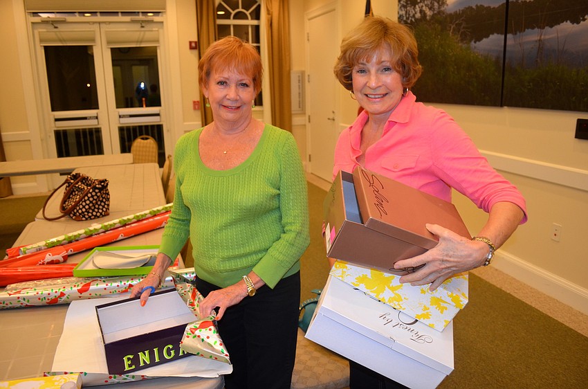 Francine Gregory and Nancy Caffiero prepare their stations for wrapping.