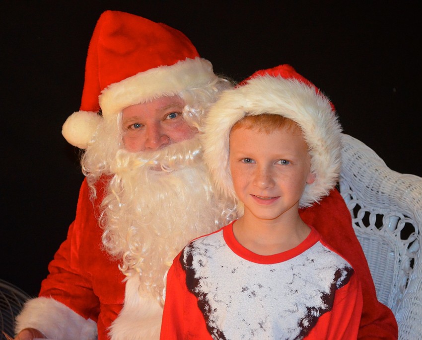 Eight-year-old Nathan Volner enjoys his minute with Santa.