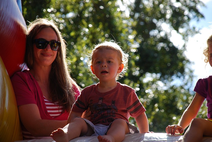 Roscoe Rann sizes up the slide with mom Barbara
