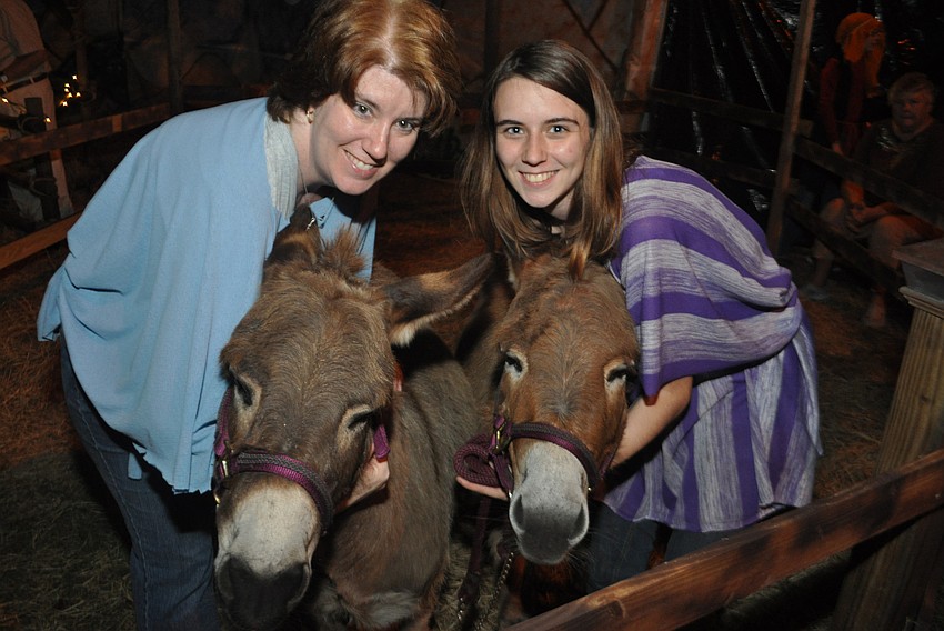 Tracy Bohlmann and her daughter, Michele, right, tend to the donkeys, Meg and Cinnastar.