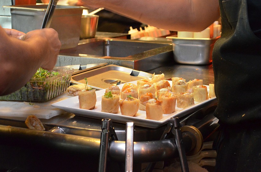 Chef Darwinâ€™s Shrimp Tequenos Roll with Avocado Aioli, Aji Chrapita Sweet Chili are prepared in the kitchen.