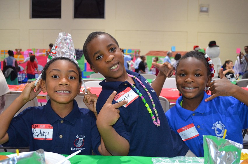 Rodney Hamilton, Samir Redden and Tyasia Gooden pull funny faces while eating dinner.