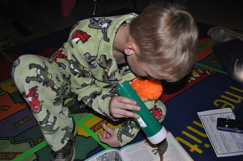 Second-grader Kyler Wade inspected the finer details of his book.