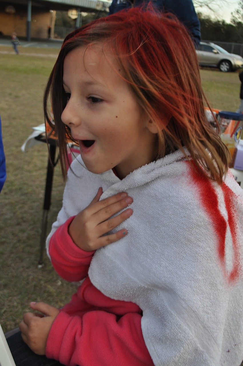 Lilyanna Bedford, 7, reacts to her new hair color.