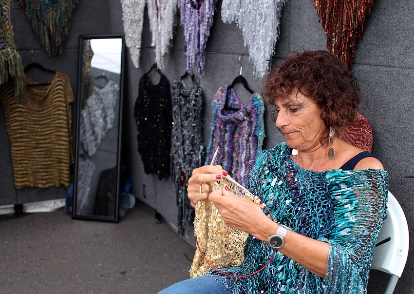 Ricki Levine works on her colorful craft at her booth, Rickiâ€™s Knit & Pearl Creations.