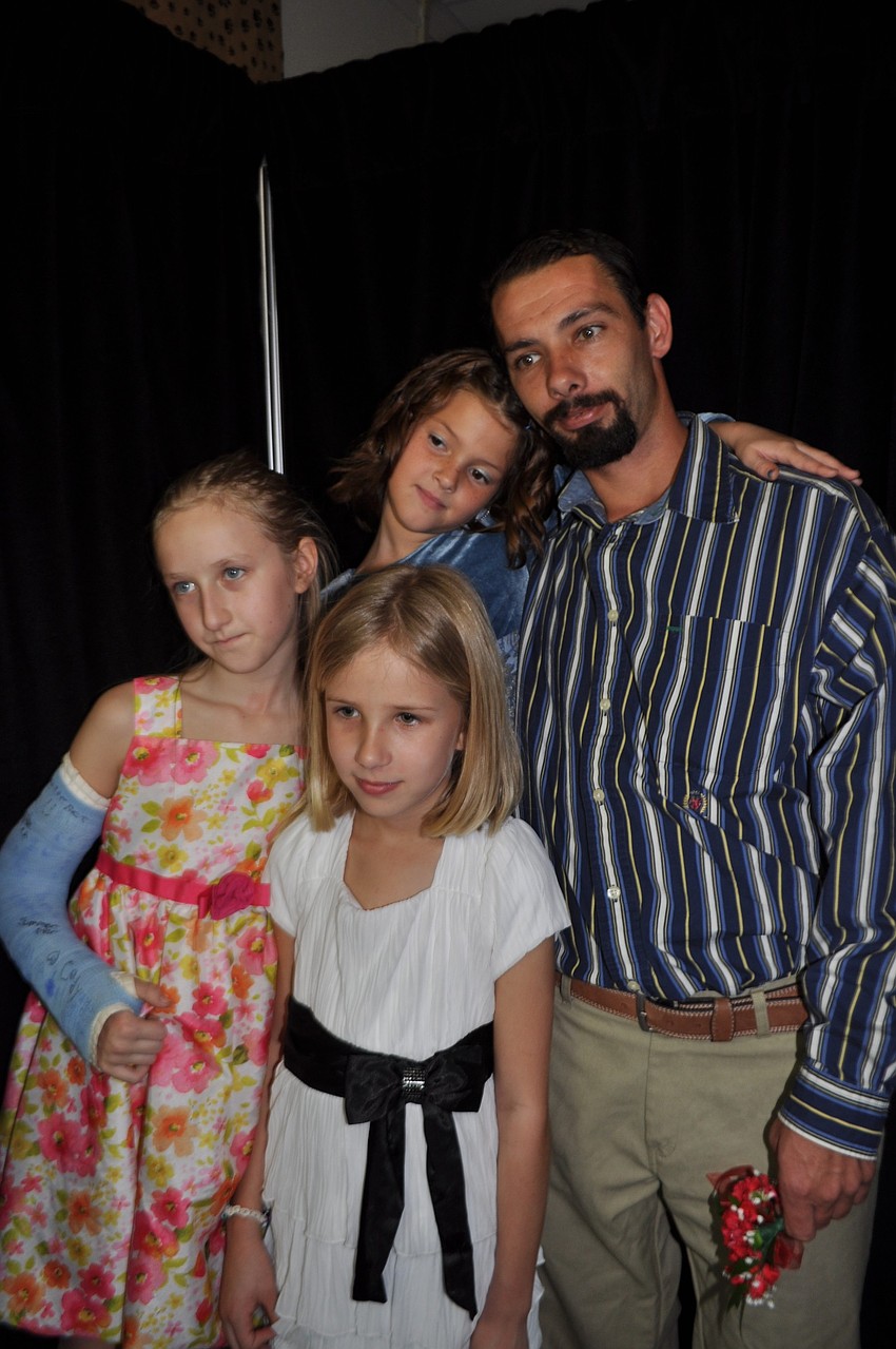 Olivia Henderson, Julia Price and Destiny and Charlie Campell, behind, pose in a picture booth.