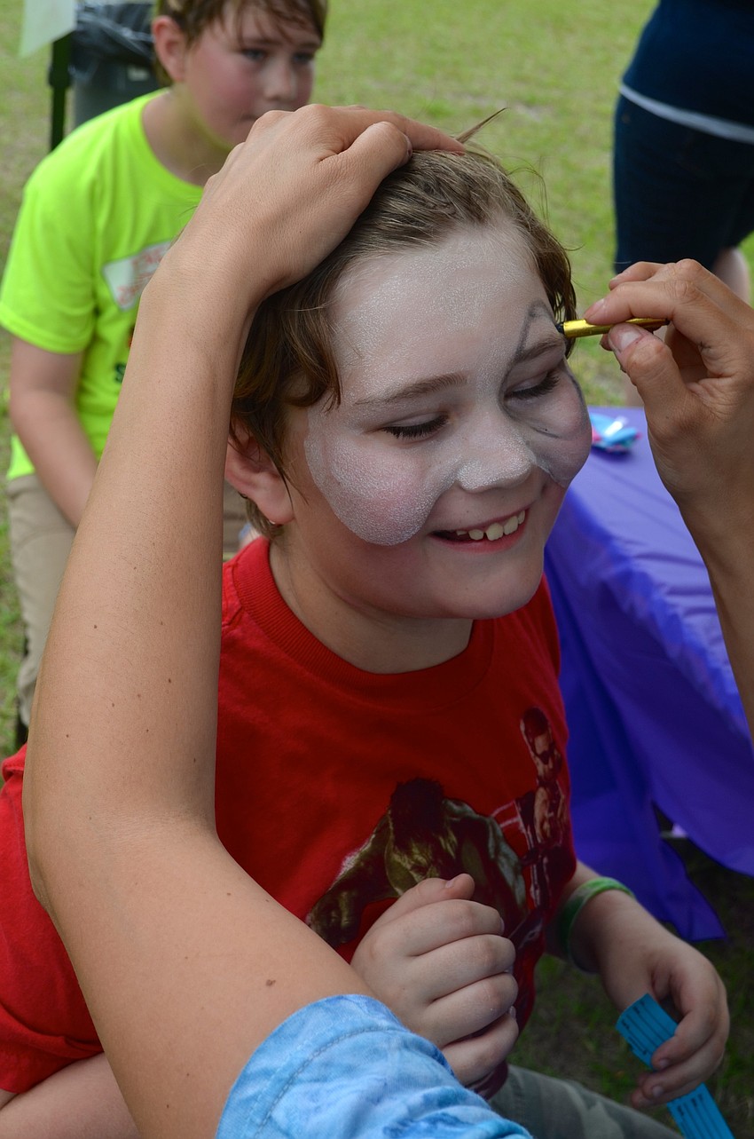 Logan Jackson, 9, waits for his face to be painted.