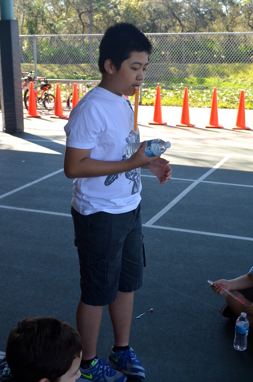 Anthony Nguyen, 10, enjoys a cold snack.