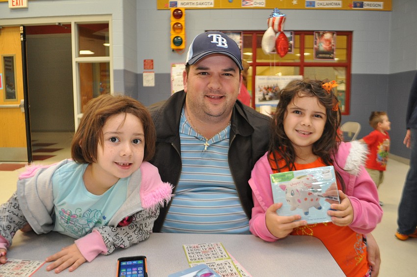 Jacob Mast plays with his daughters, Sofia, left, and Tessa, right.