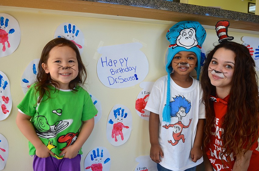 Dylan Vishinsky, 3, Dereon Edwards, 2, and Morgan Murray wish Dr. Seuss a happy (belated) birthday.