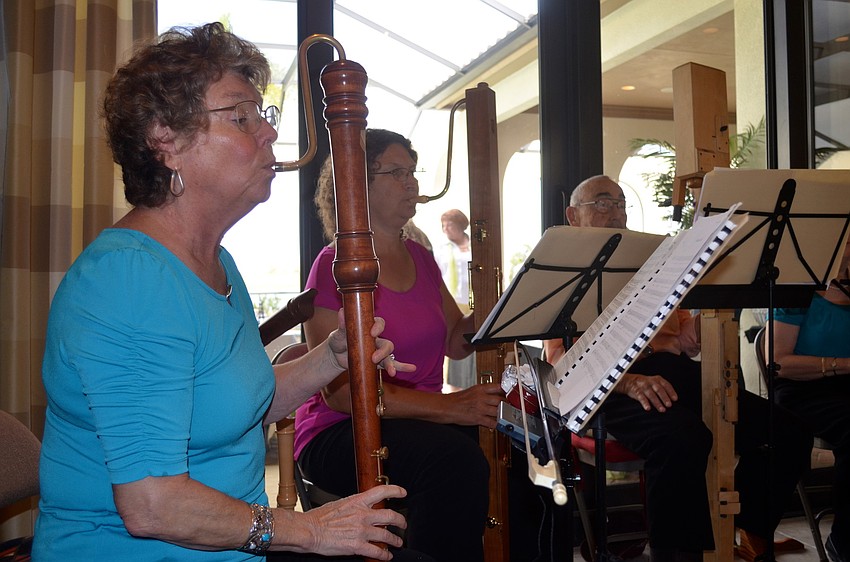 Carol Muss and Ruth Seib play wooden recorders for the crowd.