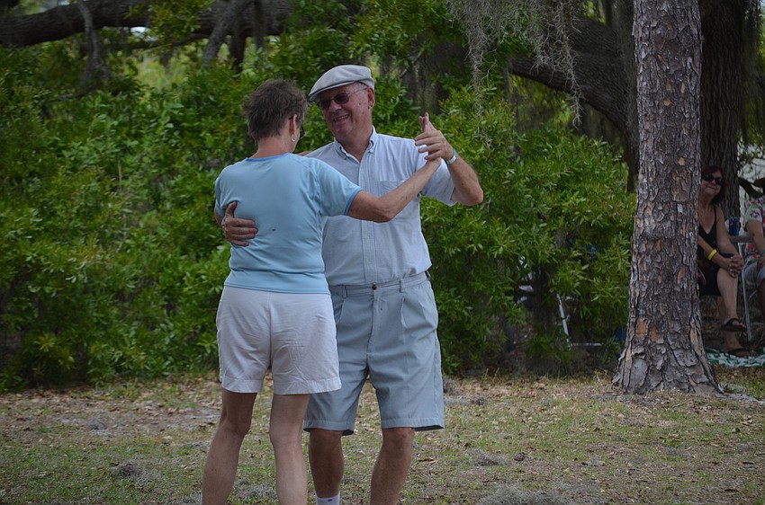 Lynn Mapes and Jane Muller dance along to the music.