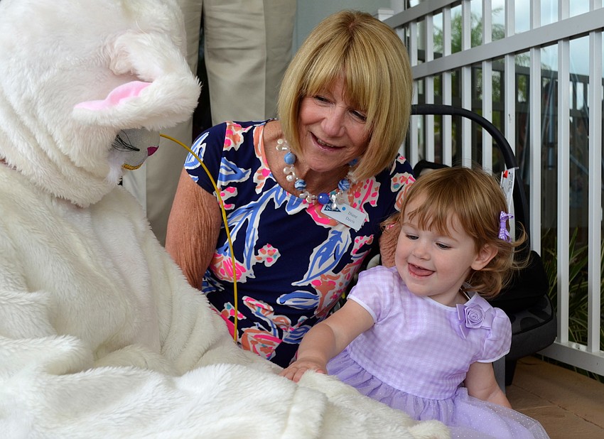 The Easter Bunny sits with Debbie Davis and February Endfield.
