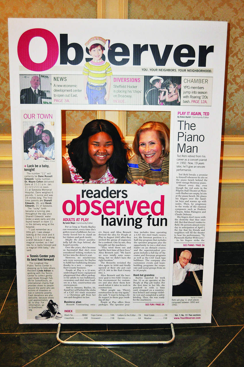 Zandy Sanders and Lisa Walsh pose inside the front cover of The Observer at Girls Inc's Celebration Luncheon April 4, at The Ritz-Carlton, Sarasota.