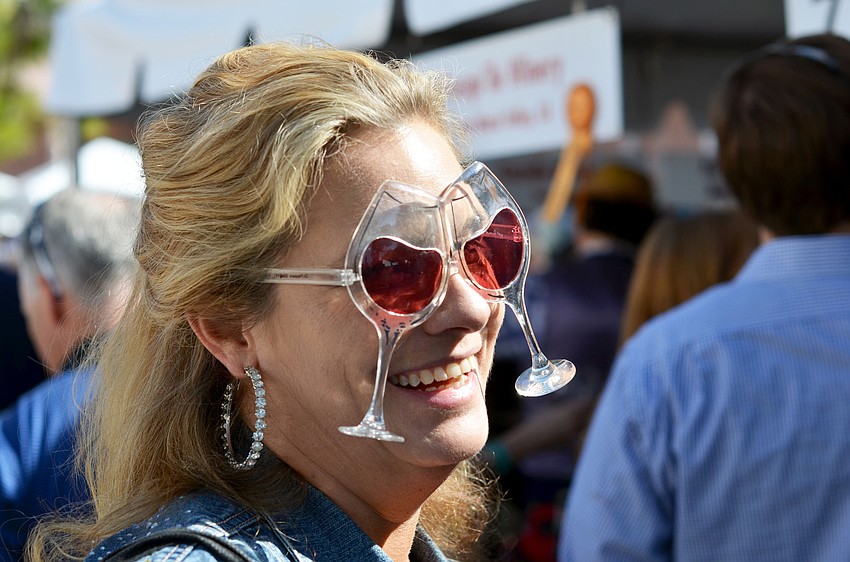 Penny Donald wears wine glasses at The Grand Tasting.