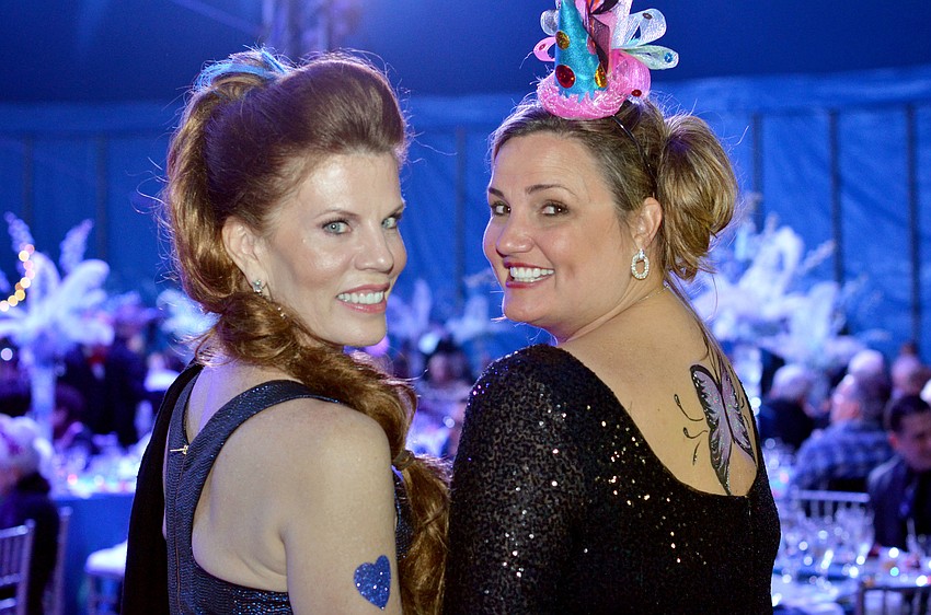 Renee Phinney and Rebecca Blitz show off their glitter tattoo art at the 2015 Circus Arts Gala.