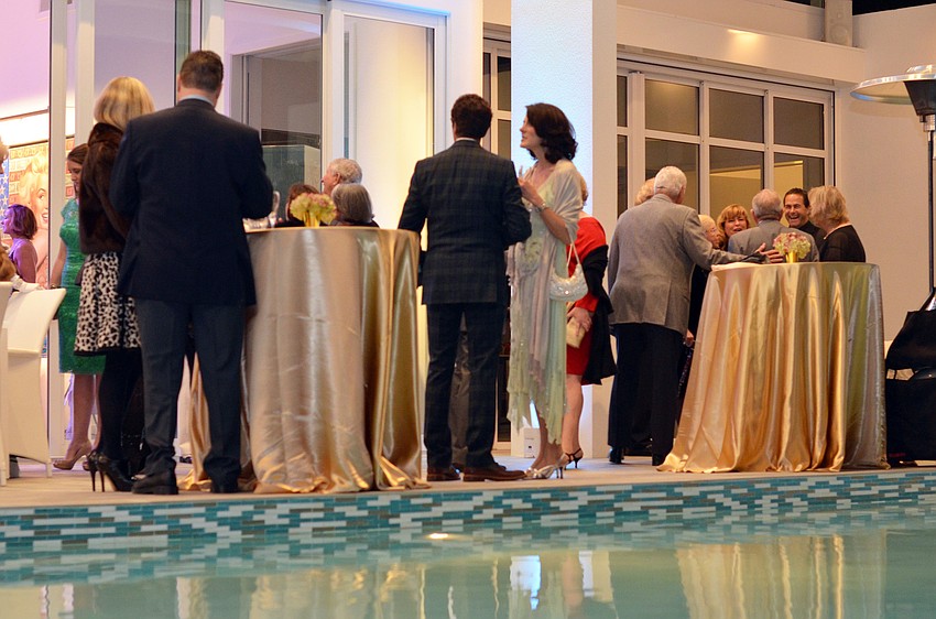 Guests gather on the patio at the home of Mark and Kim Standish for Asolo Repertory Theatreâ€™s Starry Night Dinner 3: Celebrating the Production of Our Betters.