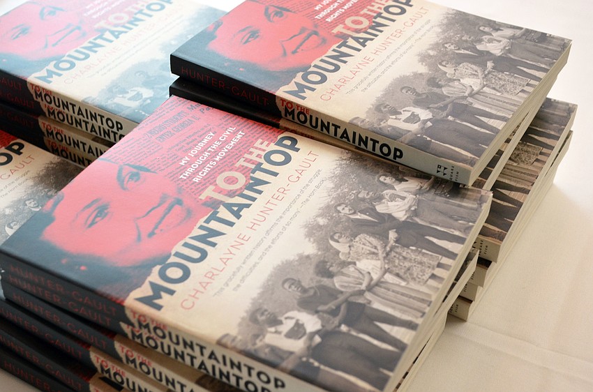 Keynote speaker Charlayne Hunter-Gault signed books for guests at Womenâ€™s Resource Center of Sarasota Countyâ€™s Let Freedom Ring Luncheon.