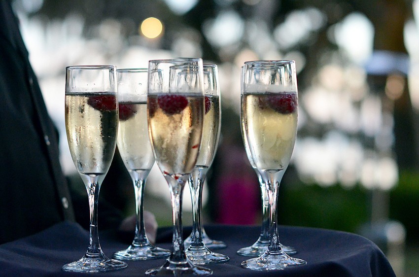 Guests sipped champagne on the lawn at Bay Preserve during the social hour at Palm Ball.