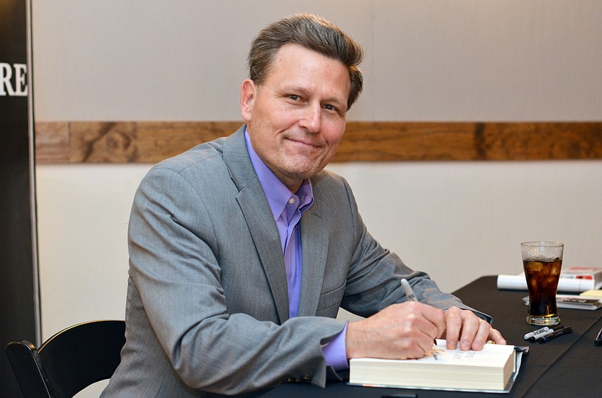 Author David Baldacci signs books at Library Foundation for Sarasota Countyâ€™s 3rd annual Author Luncheon.