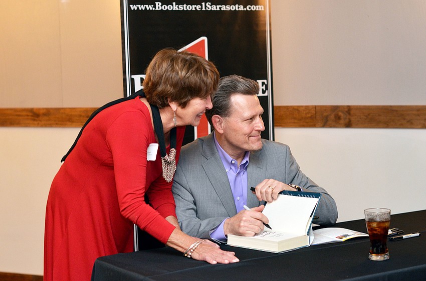 Featured author David Baldacci signs books for guests at the 3rd annual Author Luncheon.