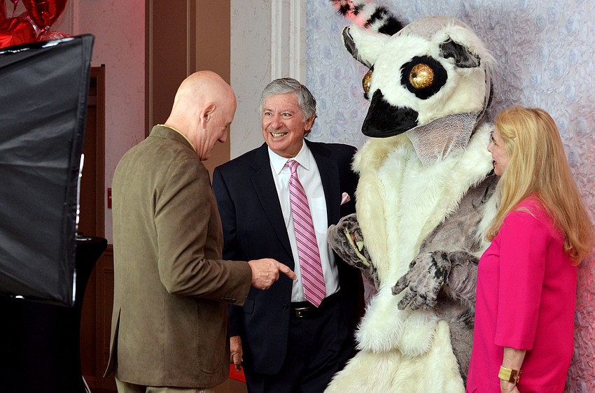 Phillip and Co-Chair Charlene Wolff get ready to have their photo taken with a lemur character.